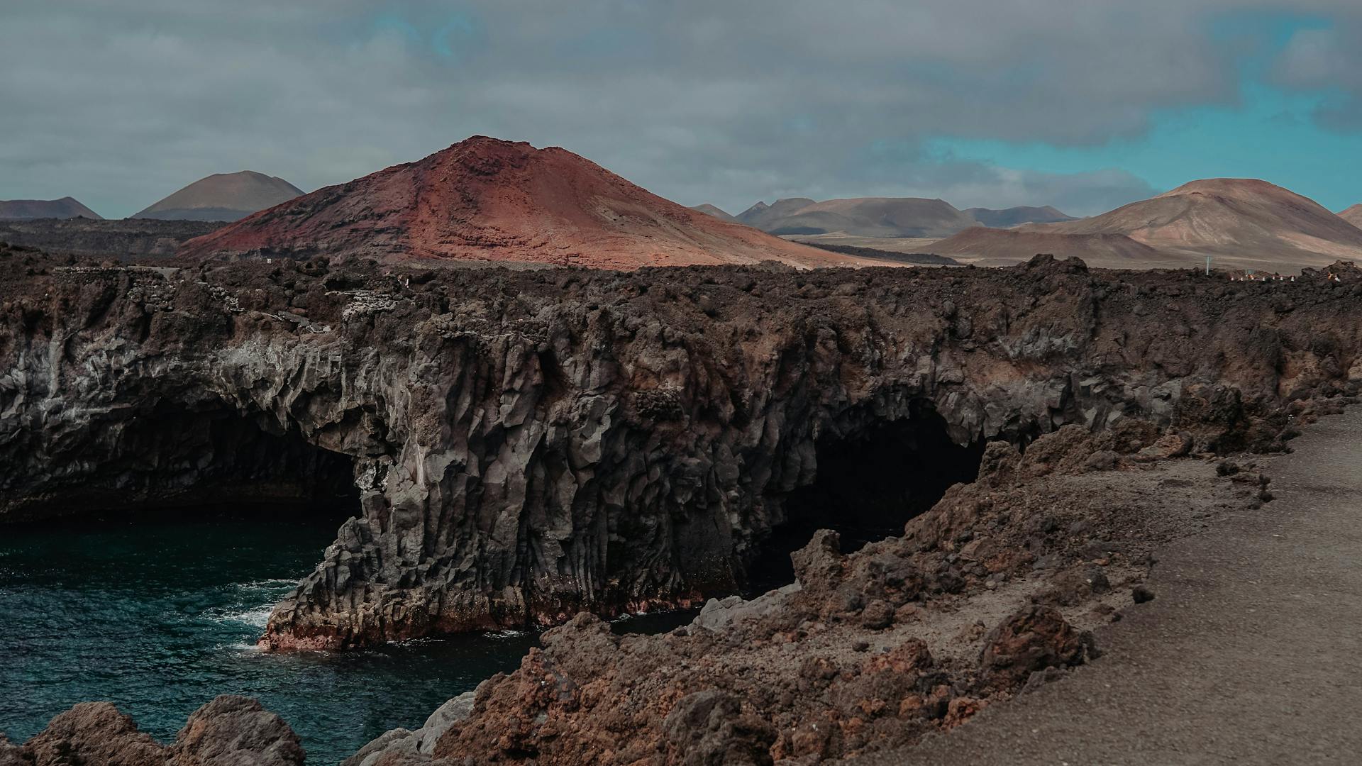 Lanzarote volcanic coastline meeting turquoise water
